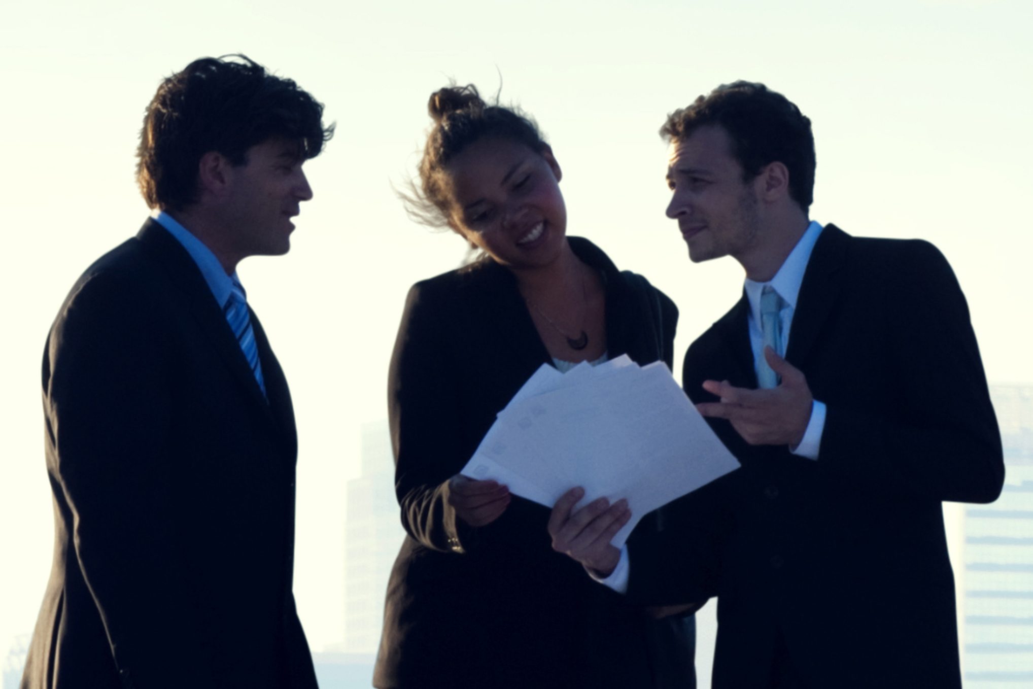 Three business professionals talking