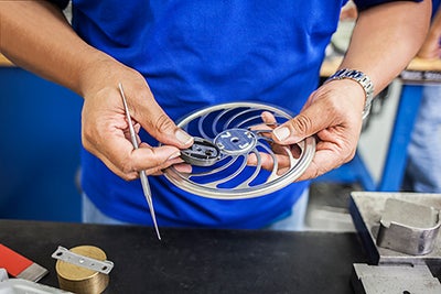 Aesculap technician examining SterilContainer part