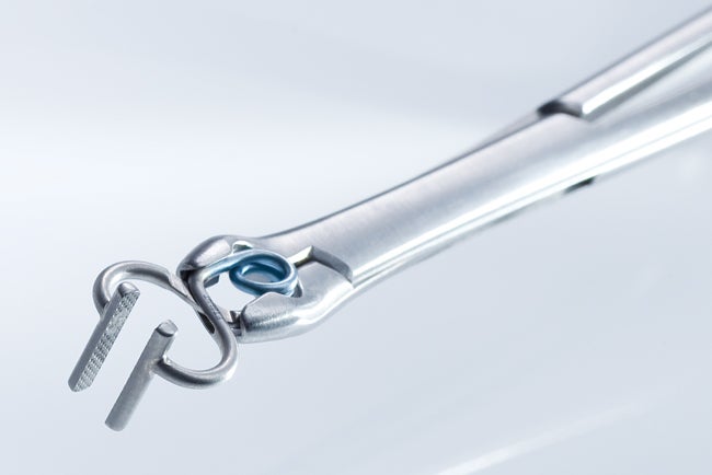 Close-up of clip applier holding T-Bar Aneurysm Clip