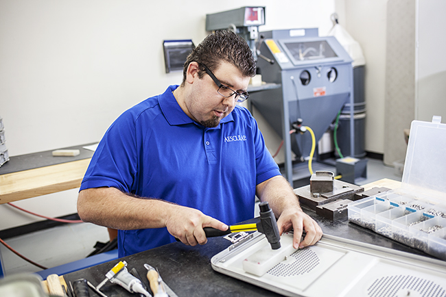 Aesculap technician repairing sterile container