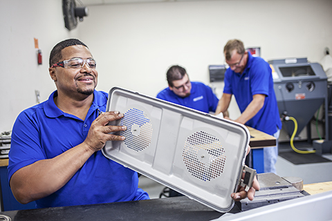 Aesculap technician examining SterilContainer lid